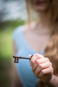 a woman holding a key in her hand