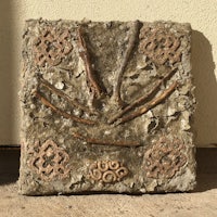 a piece of stone with a design on it
