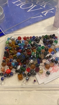 a tray full of glass beads on a table
