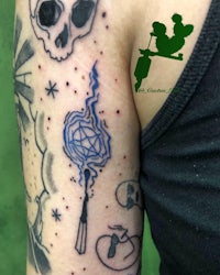 a tattoo with a skull and a wand