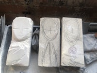 three concrete blocks with drawings on them