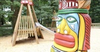 a wooden totem pole in a playground