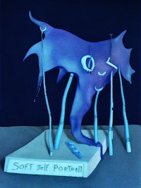 a blue sculpture with a book on top of it