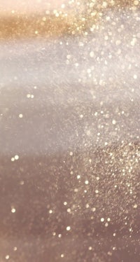 a close up of a woman with glitter on her face