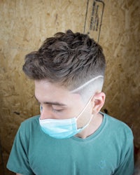 a young man wearing a surgical mask