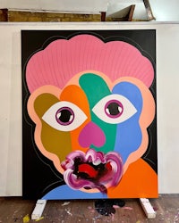 a painting of a colorful face on a canvas