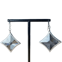 a pair of silver earrings with a square shape