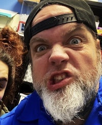 a man with a beard and a woman taking a selfie