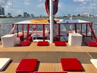 the deck of a boat with red and white cushions