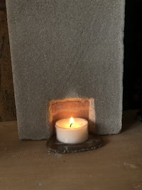 a candle is sitting on the floor next to a door