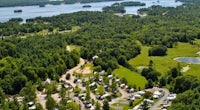 an aerial view of an rv park near a lake