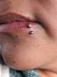 a woman with a piercing on her lip
