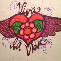 a drawing of a heart and wings with the words viva la vida