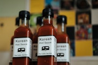 four bottles of korean hot sauce on a table