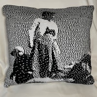 a black and white pillow with a picture of a man and a woman