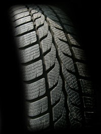 a close up of a car tire on a black background