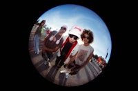 a group of people posing for a picture in a fish eye lens