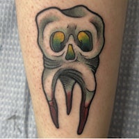a tattoo of a skull with teeth on it