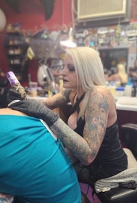 a woman getting a tattoo at a tattoo shop
