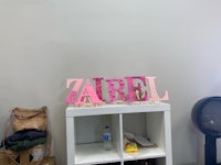 a wooden sign with the word zarel on it