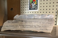 a piece of wood with a quote on it