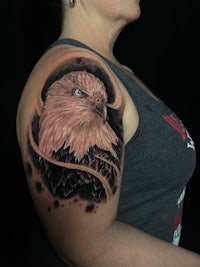 a woman with an eagle tattoo on her arm