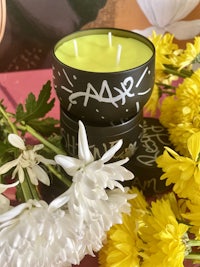 a candle surrounded by flowers and flowers