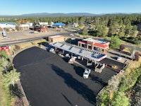 an aerial view of a gas station and parking lot
