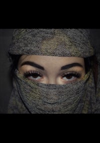 a woman with a scarf covering her face