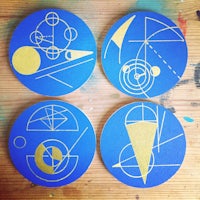 four coasters with geometric designs on them