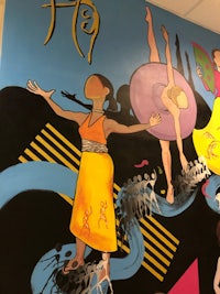 a mural depicting a group of dancers on a wall