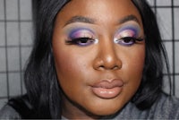 a woman with purple and blue eye makeup