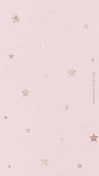 a pink wallpaper with gold stars on it