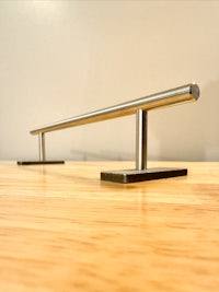 a skateboard rail sitting on top of a wooden table