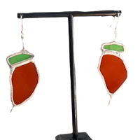 a pair of orange and green sea glass earrings on a stand