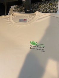 a white t - shirt with a green logo on it