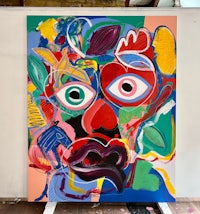 a painting of a colorful face on a easel