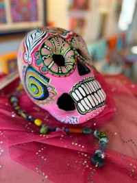 a pink sugar skull sitting on a table