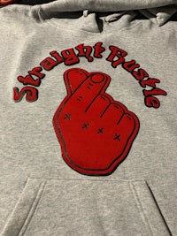 a gray hoodie with a red hand on it