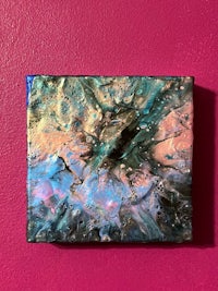 an abstract painting on a pink wall
