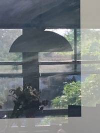 a photo of a window with a vase of flowers