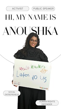 a woman holding a sign that says hi, my name is anoushika