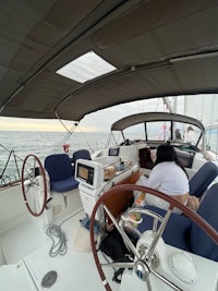 the cockpit of a sailboat with two people on board