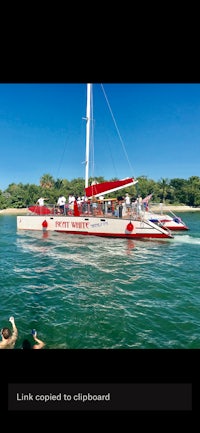 a red and white boat with people on it