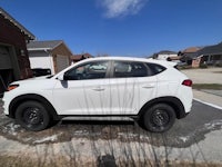 a white 2019 hyundai tucson parked in a driveway