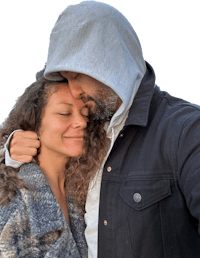 a man in a hoodie hugging a woman