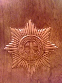 a wooden plaque with a star carved into it