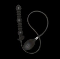 a black plastic sex toy on a black background