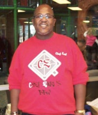 a man wearing a red t - shirt and glasses