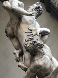 a statue of a man and a woman fighting